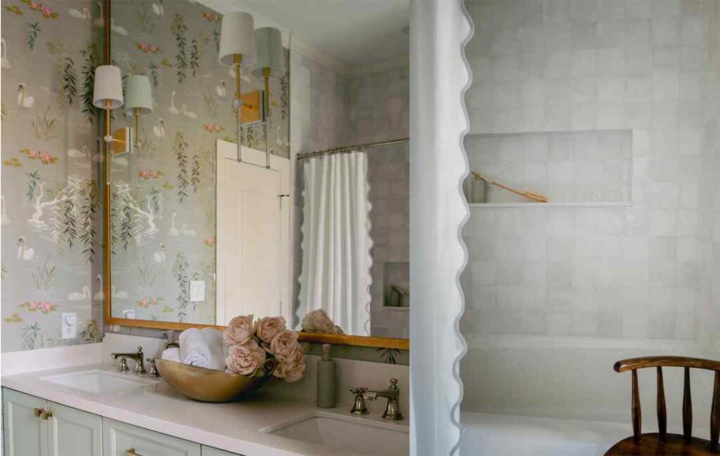 Elegant bathroom detail with layered wallpaper, brass lighting, and soft styling by CW
Interiors