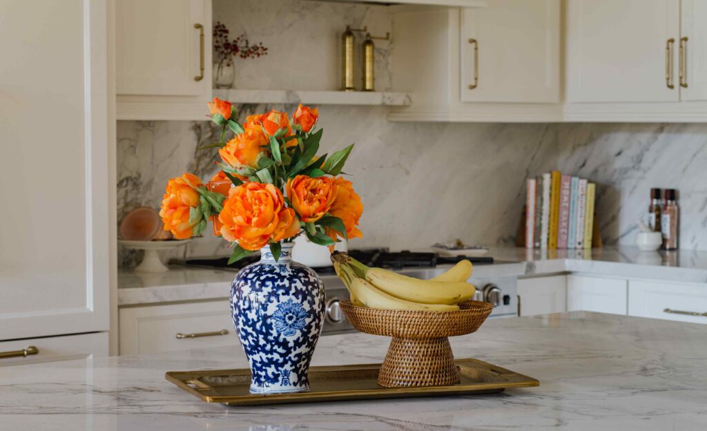 Kitchen island styling with marble, floral arrangement, and curated accessories by CW
Interiors