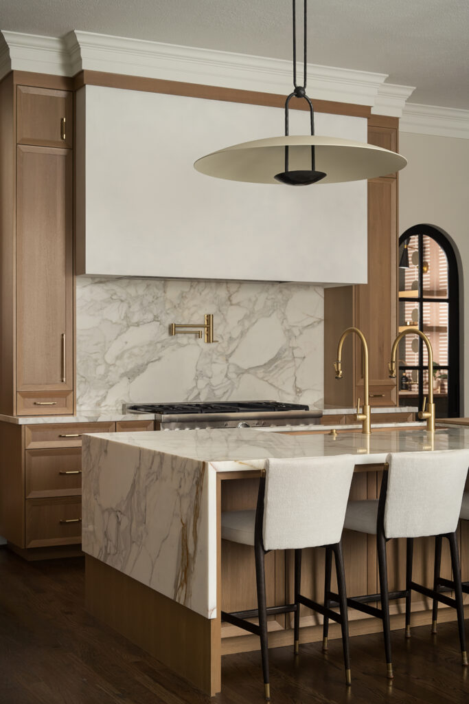 Custom millwork and stone detail at Fernside Manor by CW Interiors The Woodlands Texas.